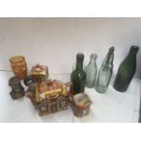 A box containing old bottles, skull figures and small collection of cottage ware.