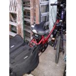 A Free Go electric folding bicycle with spare key, spare battery and charger.