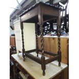 An oak side table with barley legs and a white painted bedside cabinet