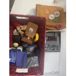 A basket of misc to include cloth with various badges, a Nokia XpressMusic mobile phone in box