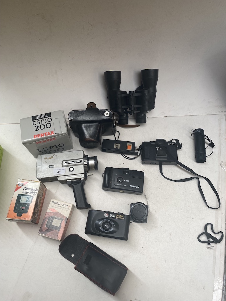 A box of cameras and related items to include Zenit, Pentax, a pair of binoculars, a Super 8 cine