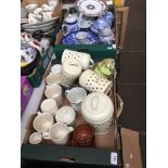 A box of blue and white pottery and a box of mixed ceramics including 4 Le Creuset mugs, sugar