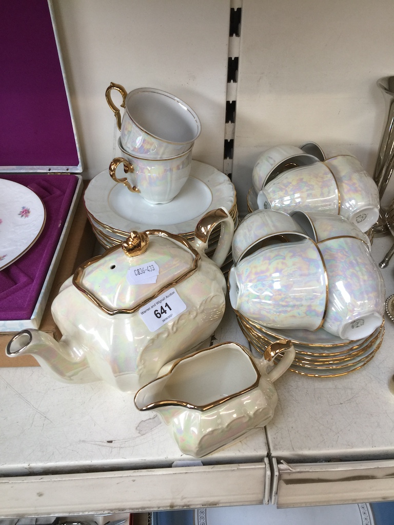 A tea set; 10 cups, 10 saucers, 10 side plates and a teapot