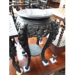A carved wood Chinese plant stand with black lacquered finish, height 75 cm and width 55cm