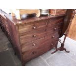 A George III mahogany chest of drawers with splayed feet.