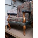 A wingback armchair with tapestry upholstery and cabriole legs, height 114cm, width 78cm and depth