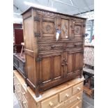 A reproduction oak cabinet, probably Titchmarsh and Goodwin or similar.