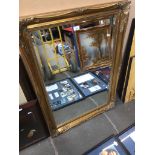 A large mirror in ornate gilded frame approx 106 x 75 cm