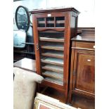 An Edwardian mahogany music cabinet with glazed door and slide out shelves, height 127cm, width 55cm