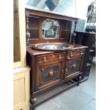 An oak sideboard with mirror back shelf