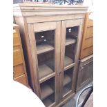 A pine glass fronted display cabinet