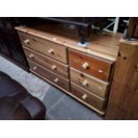 A pine chest of drawers.