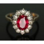 A synthetic ruby and cubic zirconia cluster ring, band marked '585', gross wt. 2.95g, size M.