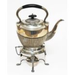 A George V silver spirit kettle, of typical form with ebony handle and ebony finial, boat shaped