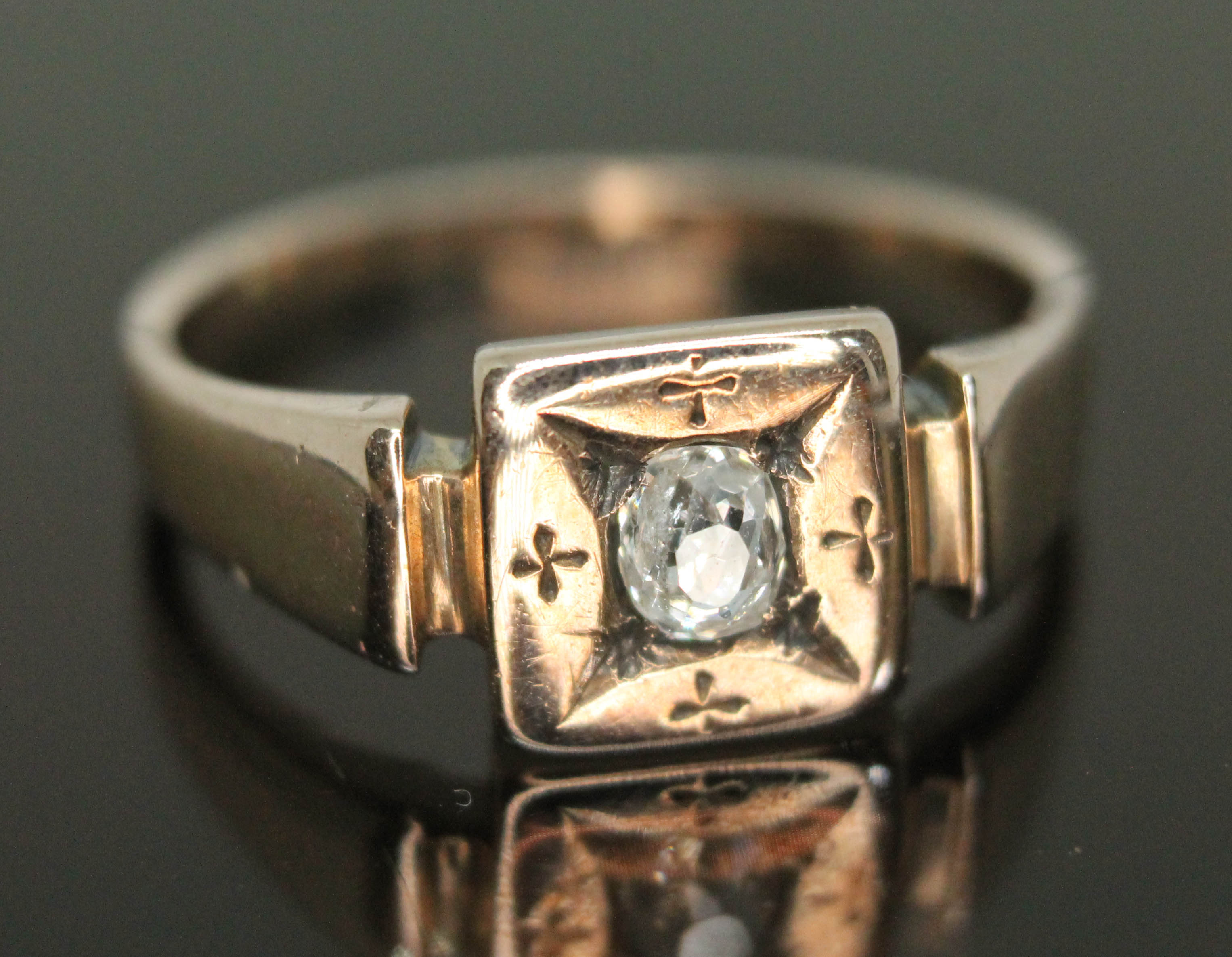 An antique diamond ring, the Old European oval stone weighing approx. 0.24 carats, band unmarked,