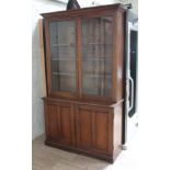 A mahogany cabinet bookcase, flared cornice top, glazed cabinet doors, the interior with