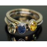 A multi-functional three part green, yellow and blue sapphire ring, two gold plated, all marked '