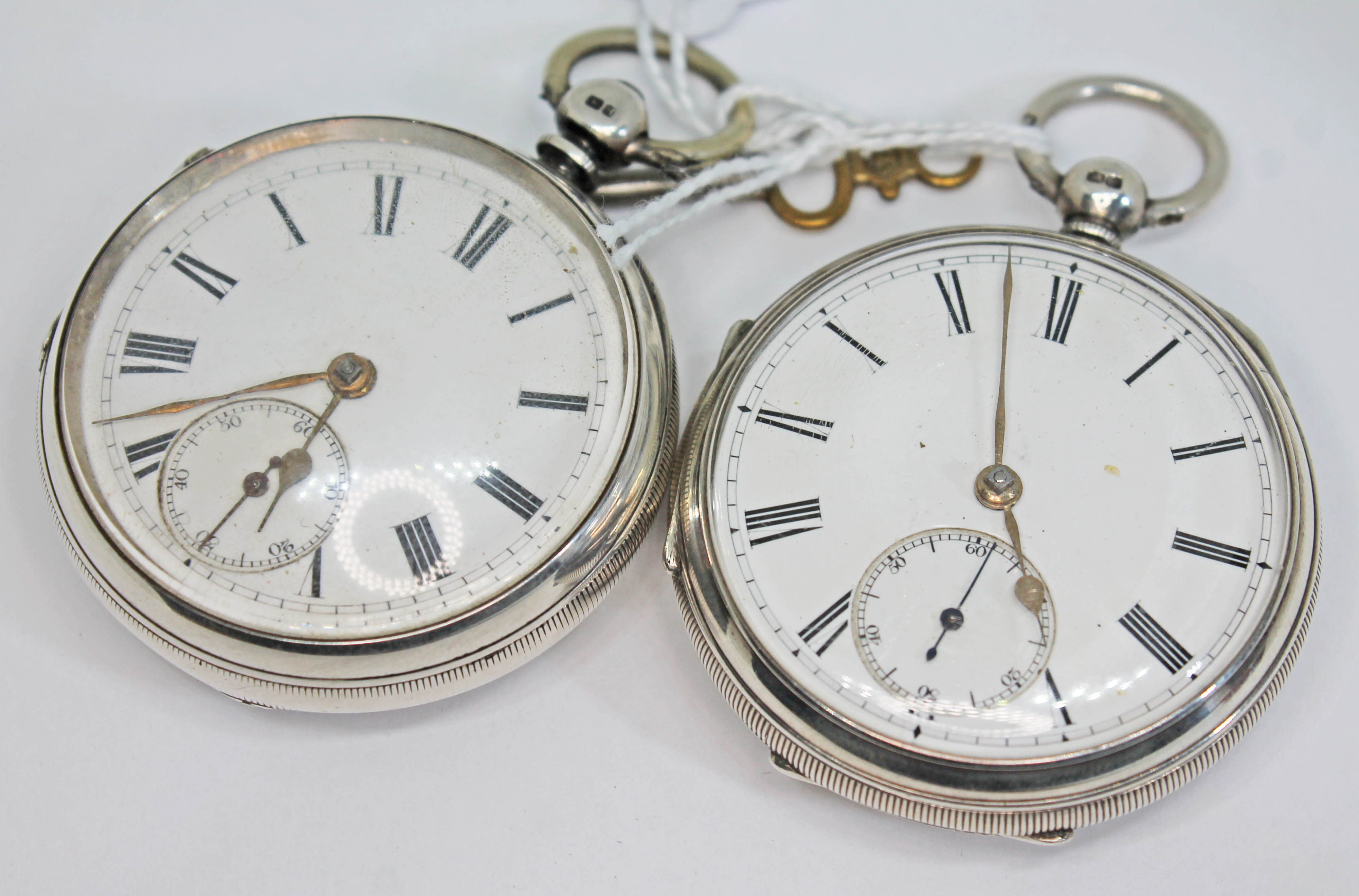 Two Victorian hallmarked silver key wind open faced pocket watches, the first with gilded fusee