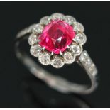 An antique pink spinel and diamond cluster ring, the central vivid pink rectangular cushion cut