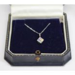 A fancy sapphire pendant on chain, featuring four princess cut sapphires in blue, pink, yellow and