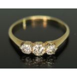 An early 20th century three stone diamond ring, the Old European cut stones weighing approx. 0.17,