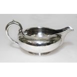 An early Victorian silver cream jug, George Ivory, London 1852, length 17.5cm, wt. 6 3/4oz.