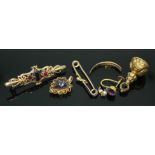 A mixed lot of gold and yellow metal comprising a hallmarked 9ct gold brooch, a heart shaped