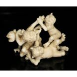 A Japanese Meji period carved ivory okimono depicting four fighting goblins, two character