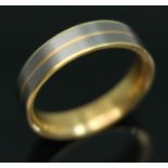 A yellow metal and titanium wedding band by Feniom, inverted D section, marked 'AU750', gross wt.