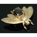 A novelty brooch modelled as a bee and set with a synthetic six ray star sapphire, marked '14K'