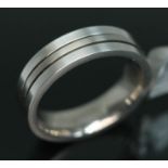A white metal wedding band by Muster, inverted D section with two outer grooves, marked 'Muster',