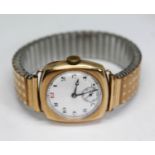 An early 20th century 9ct gold manual wind wristwatch having unsigned white enamel dial with