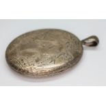 A Victorian Aesthetic stylve white metal oval locket, length 63mm, gross wt. 38.33g.