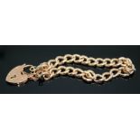 An early 20th century link bracelet with heart shaped 'padlock' clasp, marked '9c', the links marked