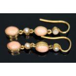 A pair of early 20th century millegrain set coral cabochon and split pearl drop earrings, marked '