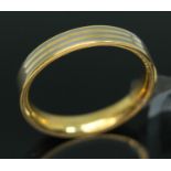 A yellow metal and titanium wedding band by Feniom, inverted D-section with alternate bands to outer