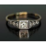 An Art Deco diamond ring, the central round brilliant cut diamond weighing approx. 0.10 carats,