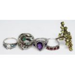 A group of five assorted rings including one formed as an entwined snake and set with sapphires,