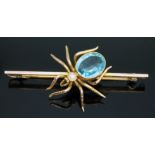 A novelty brooch modelled as a spider, millegrain set blue paste and a simulated pearl, marked '