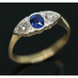 A diamond and sapphire ring, the central oval mixed cut sapphire weighing approx. 0.42 carats, set