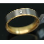 A yellow metal and titanium wedding band by Feniom, inverted D-section, the outer edge set with a