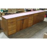 A pair of 1950s light oak kitchen units, patterned melamine tops, one with pull out slide and