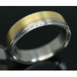 A yellow metal and steel wedding band set with three diamonds, marked 'DecoArt 8 inox AU 750 0.