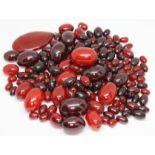 Assorted graduated cherry bakelite beads, ranging in length from approx. 10mm to 32mm, together with