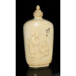 A Chinese ivory snuff bottle, one side carved in relief with two figures, the other decorated with a