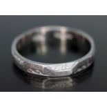 An early 20th century engraved wedding band, marked 'PLATINUM', wt. 3.07g, size N/O.