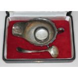 A cased hallmarked silver sauce boat and ladle, also with a hallmarked silver serviette ring, wt.