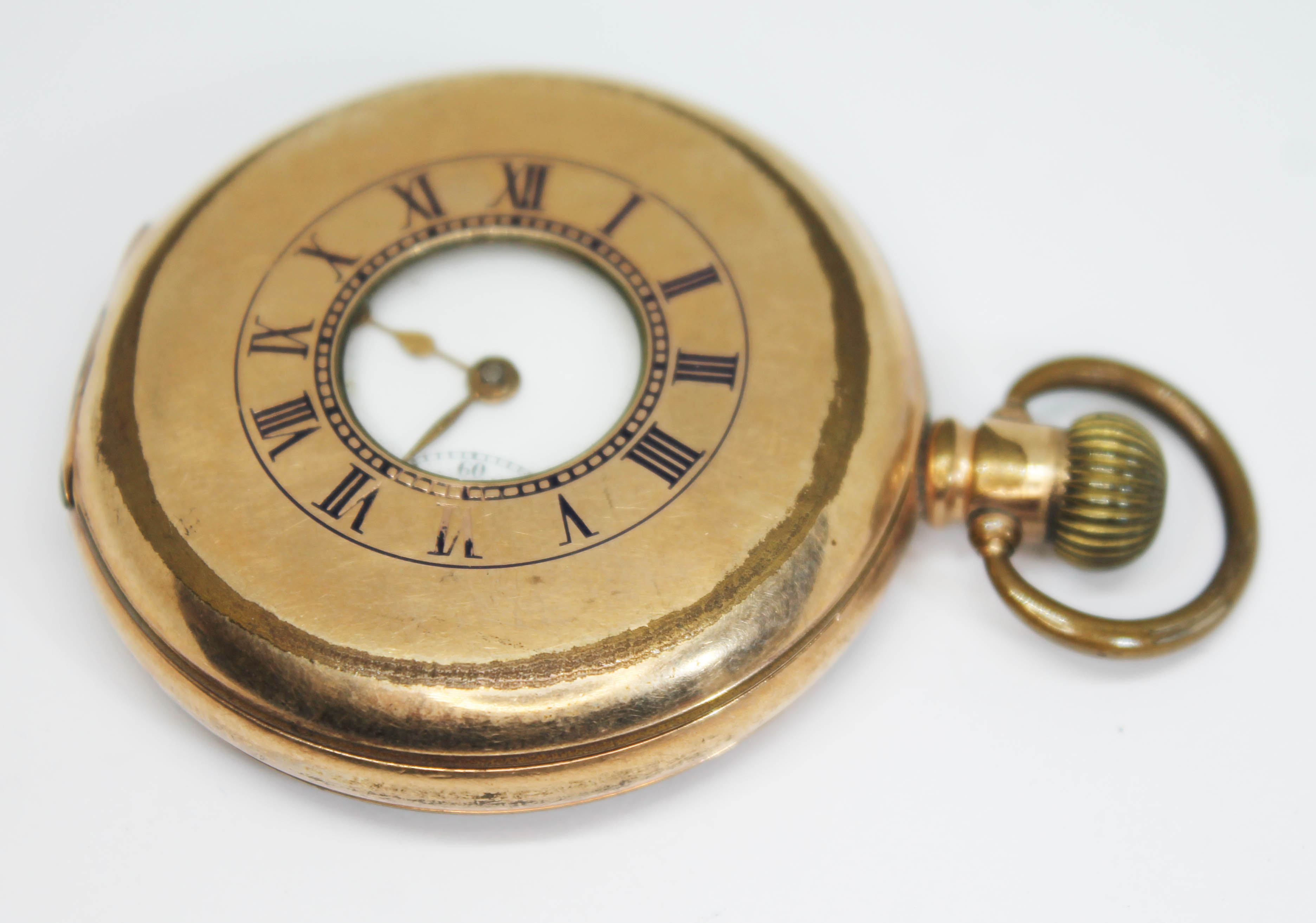 An early 20th century English made gold plated half hunter pocket watch having unsigned white enamel