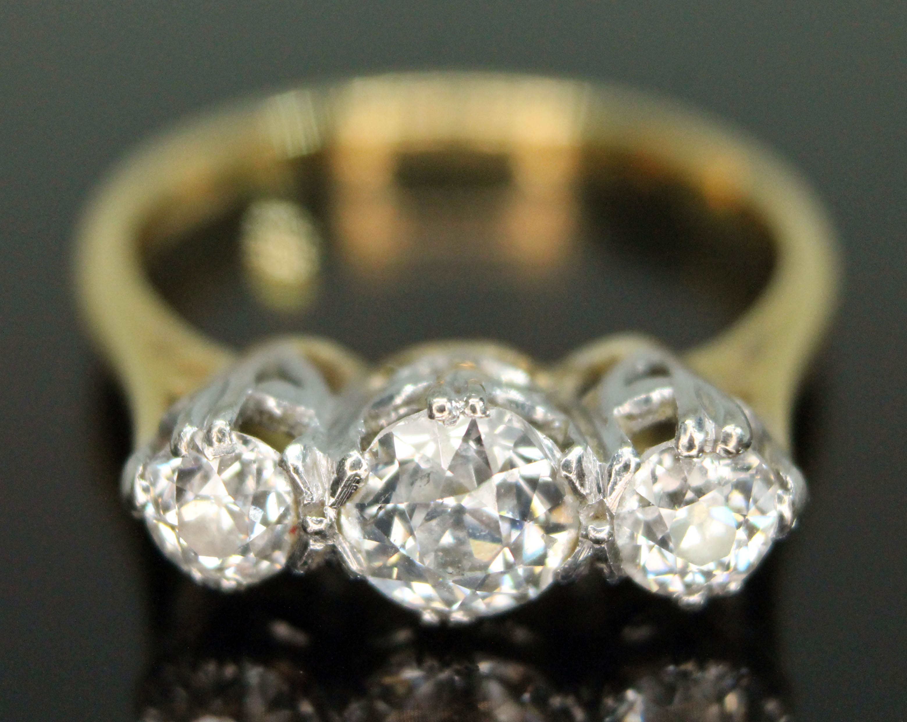 A three stone diamond ring, the Old European cut diamonds weighing approx. 0.30, 0.72 & 0.33 carats,