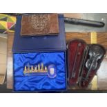 An alligator skin wallet, a miniature violin and a Golden Key souvenir key.